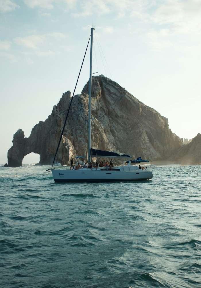 A private yacht cruising past the Arch of Cabo San Lucas